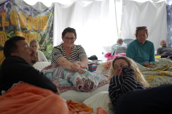 Maeleene Jessop, a former member of the Fundamentalist Church of Jesus Christ of Latter Day Saints, a polygamist offshoot of the Mormon church, second from left, talks with her fellow participants before the third and final ayahuasca ceremony during a retreat hosted by the Hummingbird Church, in Hildale, Utah, on Sunday, Oct. 16, 2022. Hummingbird is part of a growing global trend in which people are turning to ayahuasca to treat an array of health problems after conventional medications and therapy failed them. (AP Photo/Jessie Wardarski).