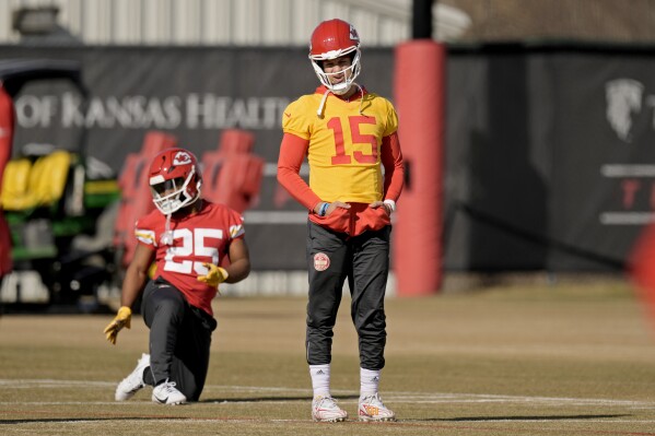 Kansas City Chiefs quarterback Patrick Mahomes and running back Clyde Edwards-Helaire (25) stretch during the team's NFL football practice Friday, Feb. 2, 2024 in Kansas City, Mo. The Chiefs will play the San Francisco 49ers in Super Bowl 58. (AP Photo/Charlie Riedel)