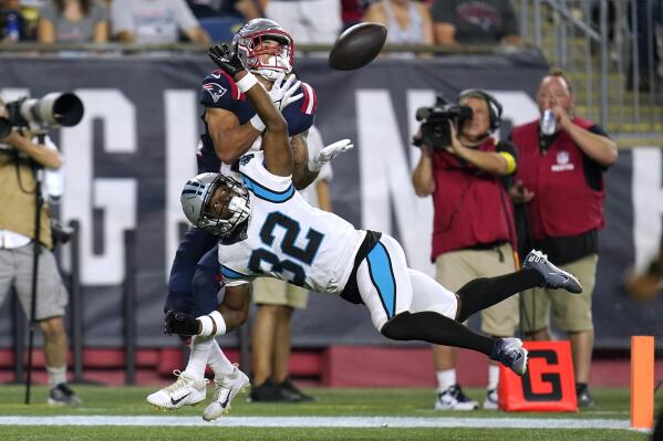 New England Patriots wide receiver Tre Nixon, behind, can't make the reception as Carolina Panthers cornerback Tae Hayes (32) defends during the second half of a preseason NFL football game Friday, Aug. 19, 2022, in Foxborough, Mass. (AP Photo/Charles Krupa)