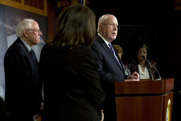 Sen. Patrick Leahy, D-Vt. accompanied by Sen. Bernie Sanders, I-Vt., Rep. Pramila Jayapal, D-Wash., and other members, speaks during a news conference on a measure limiting President Donald Trump's ability to take military action against Iran, on Capitol Hill, in Washington, Thursday, Jan. 9, 2020. (AP Photo/Jose Luis Magana)
