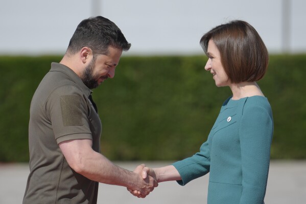 FILE - Moldova's President Maia Sandu, right, greets Ukraine's President Volodymyr Zelenskyy in Bulboaca, Moldova, June 1, 2023. She has been a frequent target of online disinformation created with artificial intelligence. (AP Photo/Vadim Ghirda, File)
