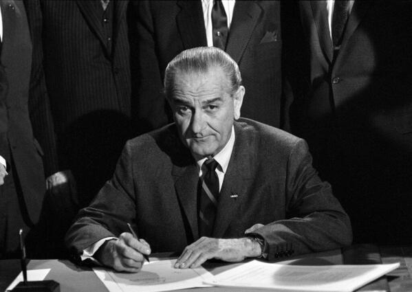 President Johnson signed into law the new Civil Rights Bill, April 11, 1968, in Washington. The bill signing ceremony took place in the East Room in the White House. (AP Photo)