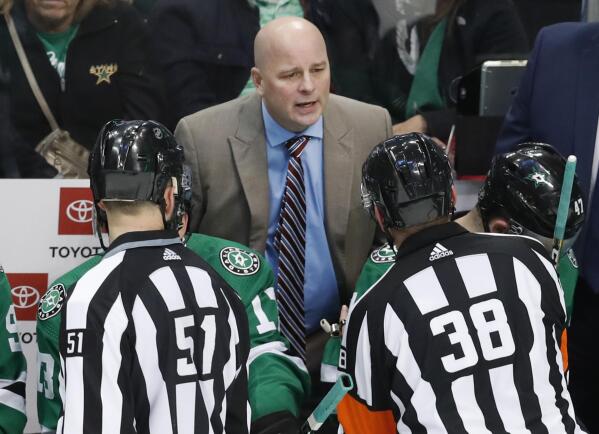 FILE - Dallas Stars head coach Jim Montgomery talks to officials during the second period of an NHL hockey game against the Arizona Coyotes in Dallas, Monday, Feb. 4, 2019. The Boston Bruins have hired Jim Montgomery as their new coach, giving the hockey lifer another chance at an NHL head-coaching job less than three years since he lost his first one. Recently extended general manager Don Sweeney announced the hire Friday, July 1, 2022. (AP Photo/LM Otero)