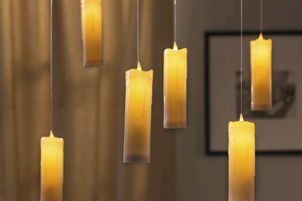 This photo provided by Balsam Hill shows their battery-operated floating candle set. Displayed indoors or out, it creates a spooky aura that might even evoke Harry Potter for some. (Balsam Hill via AP)