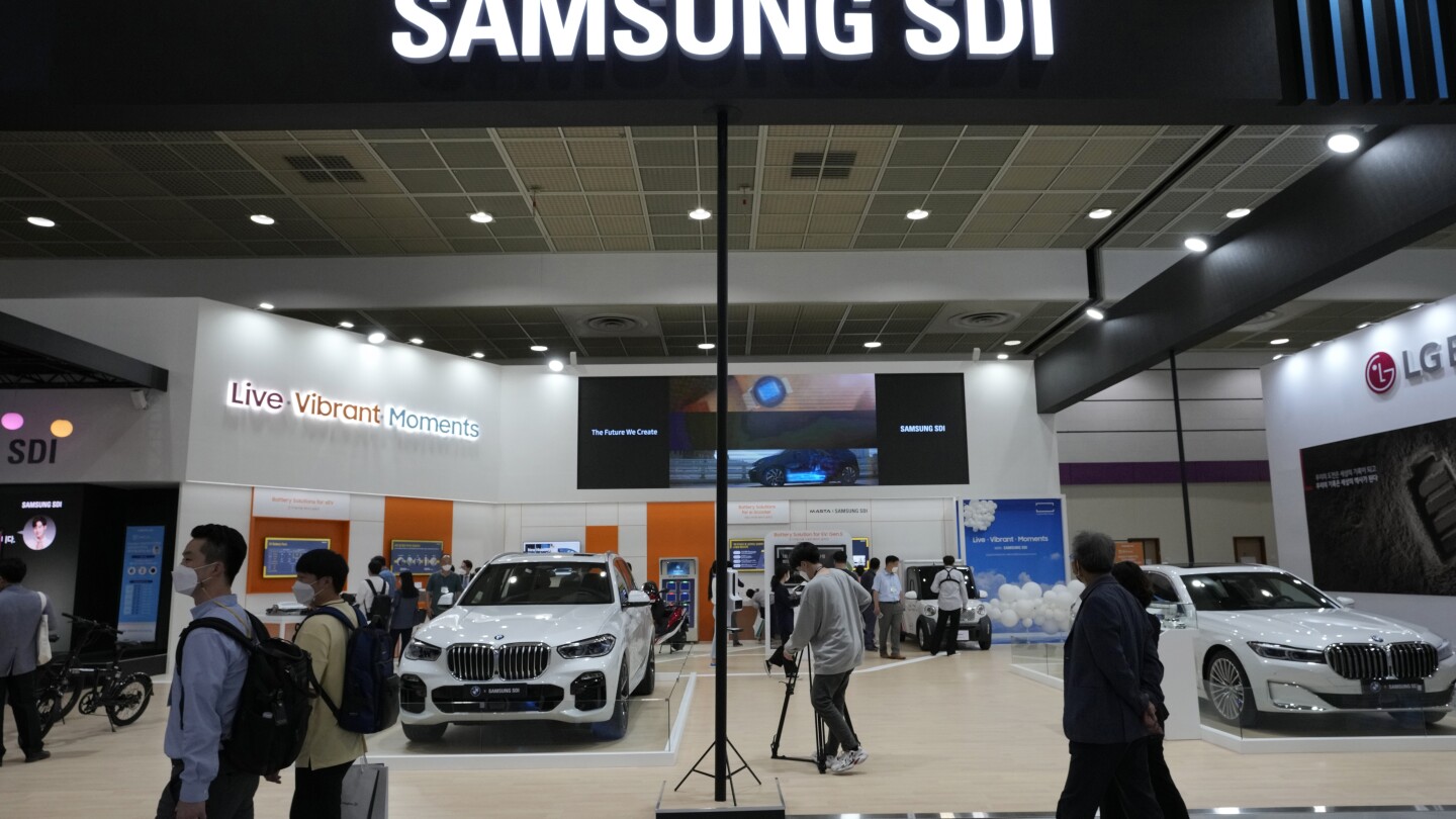 FILE - People walk by Samsung SDI Co.’ booth during the InterBattery 2021, the country’s leading battery exhibition, at COEX in Seoul, South Korea