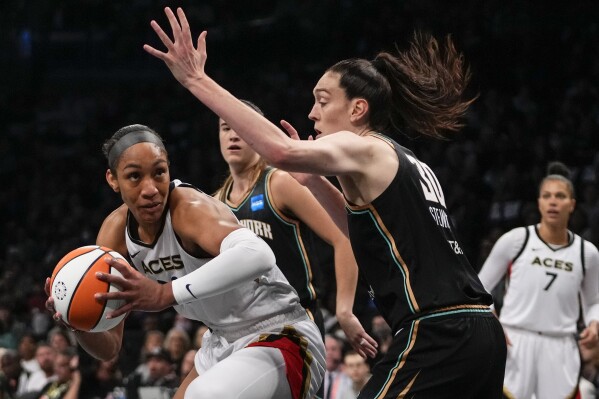 New York Liberty's Breanna Stewart defends Las Vegas Aces' A'ja Wilson during the first half in Game 3 of a WNBA basketball final playoff series, Sunday, Oct. 15, 2023, in New York. (AP Photo/Frank Franklin II)