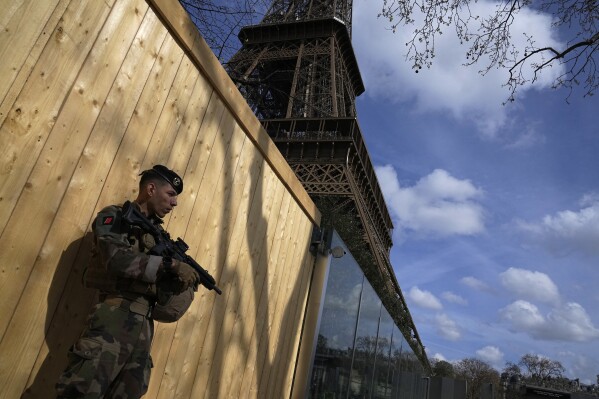 A soldier patrols at the Eiffel Tower, Monday, March 25, 2024 in Paris. France's government increased its security alert posture to the highest level Sunday March 24, 2024 after the deadly attack at a Russian concert hall and the Islamic State's claim of responsibility. (AP Photo/Michel Euler)