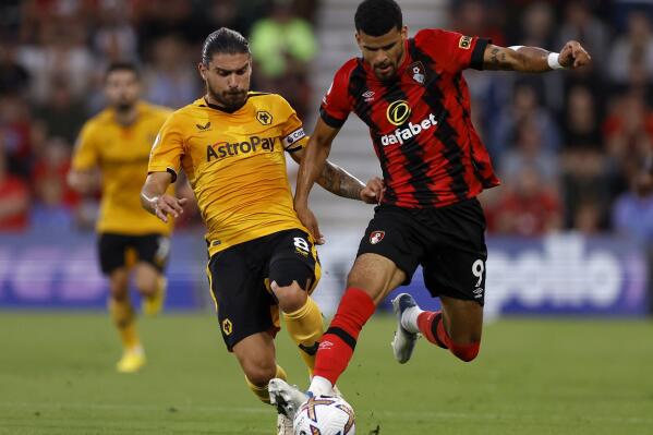 Wolverhampton Wanderers' Ruben Neves, left, and Bournemouth's Dominic Solanke battle for the ball during the English Premier League soccer match at the Vitality Stadium, Bournemouth, England, Wednesday Aug. 31, 2022. (Steven Paston/PA via AP)