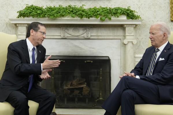 FILE - President Joe Biden meets with Israel's President Isaac Herzog in the Oval Office of the White House in Washington, July 18, 2023. As Biden prepares to meet Israeli Prime Minister Benjamin Netanyahu this week in New York, a new poll finds that while Americans generally view Israel as a partner or ally, many question whether his far-right government shares American values. (AP Photo/Susan Walsh, File)