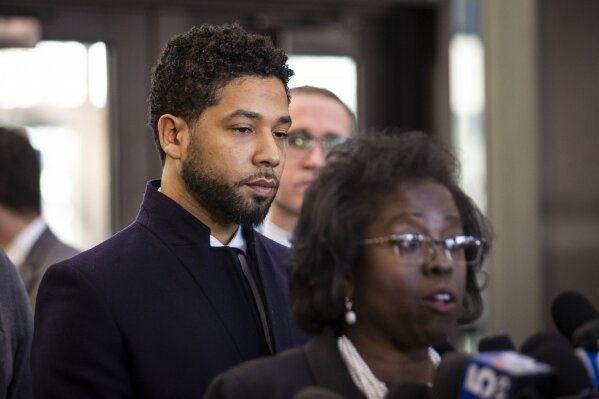 
              Actor Jussie Smollett, right, listens as his attorney, Patricia Brown Holmes, speaks to reporters at the Leighton Criminal Courthouse after prosecutors dropped all charges against him on Tuesday, March 26, 2019. (Ashlee Rezin/Sun-Times/Chicago Sun-Times via AP)
            