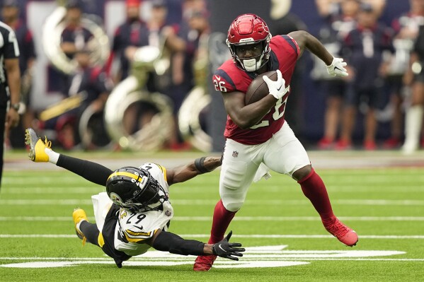 Houston Texans running back Devin Singletary (26) breaks away from Pittsburgh Steelers cornerback Levi Wallace (29) during the second half of an NFL football game Sunday, Oct. 1, 2023, in Houston. (AP Photo/David J. Phillip)