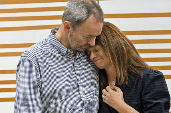 Simon and Sally Glass comfort each other during an emotional news conference in Denver on Tuesday, Sept. 13, 2022. They are calling for accountability after police shot and killed their 22-year-old son, Christian Glass, after he called 911 for roadside assistance in the Colorado mountain town of Silver Plume in June. The Glasses say their son was having a mental health episode, and police needlessly escalated the situation. (AP Photo/Thomas Peipert)