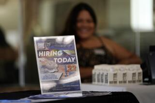 FILE - A hiring sign is placed at a booth for prospective employers during a job fair Wednesday, Sept. 22, 2021, in the West Hollywood section of Los Angeles.  The number of Americans applying for unemployment benefits rose to the highest level in three months as the fast-spreading omicron variant disrupted the job market. Jobless claims rose for the third straight week — by 55,000 to 286,000, highest since mid-October, the Labor Department reported Thursday, Jan. 20, 2022.  (AP Photo/Marcio Jose Sanchez)
