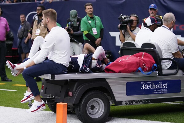 Houston Texans wide receiver Tank Dell is taken off the field after being injured in the first half of an NFL football game against the Denver Broncos Sunday, Dec. 3, 2023, in Houston. (AP Photo/Eric Christian Smith)