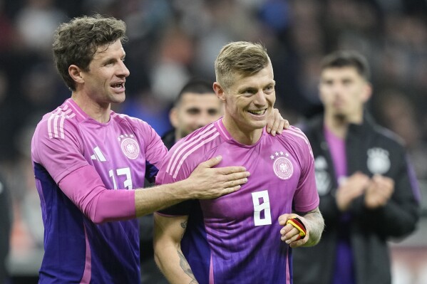 Germany's Thomas Muller, left, and Germany's Toni Kroos smile after the international friendly soccer match between Germany and Netherlands at the Deutsche Bank Park in Frankfurt, Germany on Tuesday, March 26, 2024. (AP Photo/Martin Meissner)