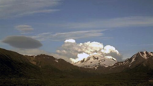 This web camera image provided by the U.S. Geological Survey shows a low-level ash plume from the Shishaldin Volcano captured on Tuesday, July 18, 2023. An ongoing eruption of a remote volcano in Alaska's Aleutian Islands produced an ash cloud so large Tuesday warnings were sent to pilots about potentially dangerous conditions.(Alaska Volcano Observatory/U.S. Geological Survey via AP)