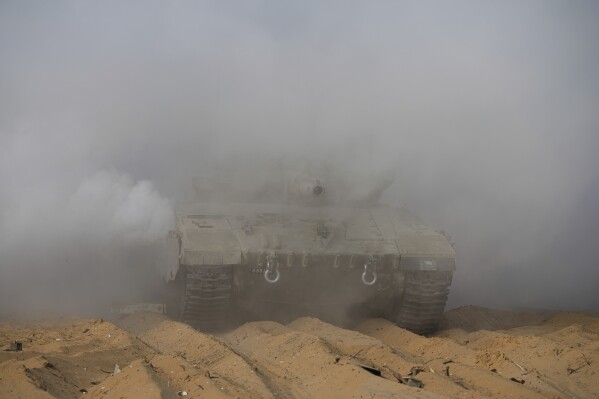 Israeli tanks maneuver near the Israeli-Gaza border, southern Israel, Monday, Nov. 13, 2023. (AP Photo/Tsafrir Abayov)