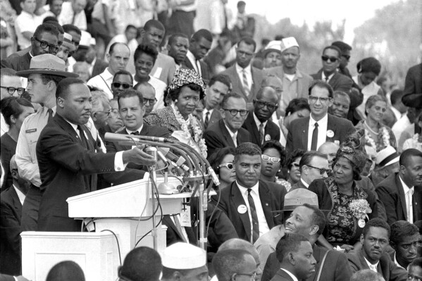 FILE - The Rev. Dr. Martin Luther King Jr., head of the Southern Christian Leadership Conference, speaks to thousands during his 