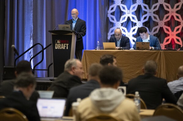 Jeff Pfeifer, top left, leads the Rule 5 Draft during the Major League Baseball winter meetings Wednesday, Dec. 6, 2023, in Nashville, Tenn. (APPhoto/George Walker IV)