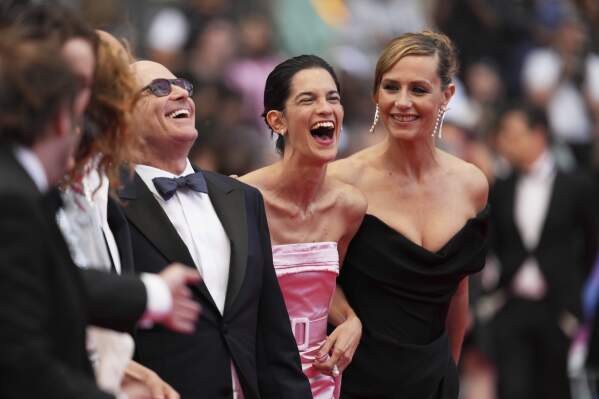 Bruno Levy, from left, Suzanne Lindon and Cecile de France pose for photographers upon arrival at the premiere of the film 'Colours of Time' at the 78th international film festival, Cannes, southern France, Thursday, May 22, 2025. (AP Photo/Natacha Pisarenko)