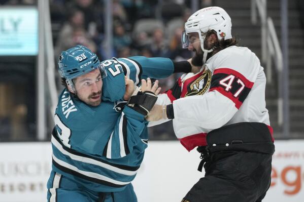 Ottawa Senators center Mark Kastelic (47) punches San Jose Sharks defenseman Nick Cicek during the second period of an NHL hockey game in San Jose, Calif., Monday, Nov. 21, 2022. (AP Photo/Godofredo A. Vásquez)