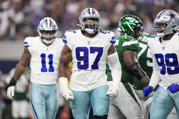 Dallas Cowboys defensive tackle Osa Odighizuwa celebrates after a sack against the New York Jets during the second half of an NFL football game in Arlington, Texas, Sunday, Aug. 17, 2023. (AP Photo/Tony Gutierrez)