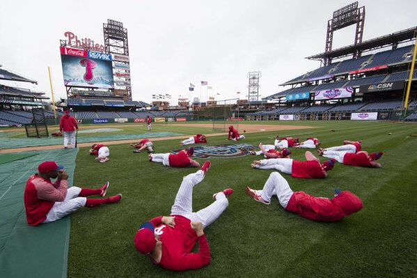 FILE - In this April 7, 2017, file photo, members of the Philadelphia Phillies stretch before the team's baseball game against the Washington Nationals in Philadelphia. Five players for the Philadelphia Phillies have tested positive for COVID-19 at the team's spring camp in Florida, prompting the club to indefinitely close the complex.
The team also said Friday, June 19, 2020, that three staff members at the camp have tested positive. The club didn't identify any of those affected. (AP Photo/Matt Rourke, File)