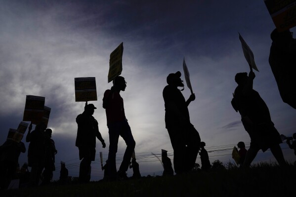 FILE - UPS teamsters and workers hold a rally, Friday, July 21, 2023, in Atlanta, as a national strike deadline nears. UPS has reached a contract agreement with its 340,000-person strong union Tuesday, July 25, averting a strike that had the potential to disrupt logistics nationwide for businesses and households alike. (AP Photo/Brynn Anderson, File)