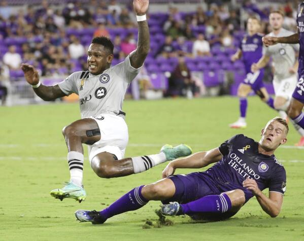 CF Montreal's Romell Quioto, left, leaps over Orlando City's Robin Jansson during an MLS soccer match in Orlando, Fla., Wednesday, Sept. 15, 2021. (Stephen M. Dowell/Orlando Sentinel via AP)