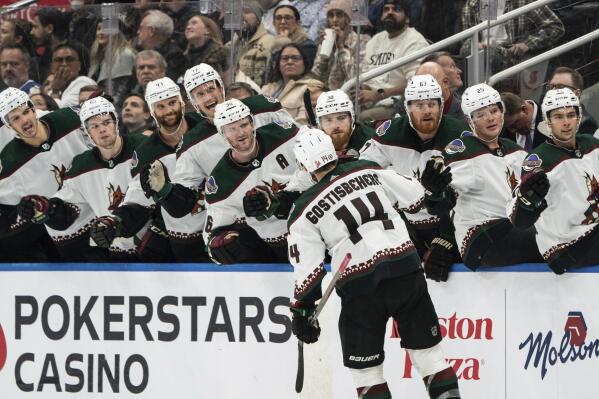 Arizona Coyotes defenseman Shayne Gostisbehere (14) celebrates with teammates after scoring the winning powerplay goal against the Toronto Maple Leafs during third-period NHL hockey game action in Toronto, Monday, Oct. 17, 2022. (Alex Lupul/The Canadian Press via AP)