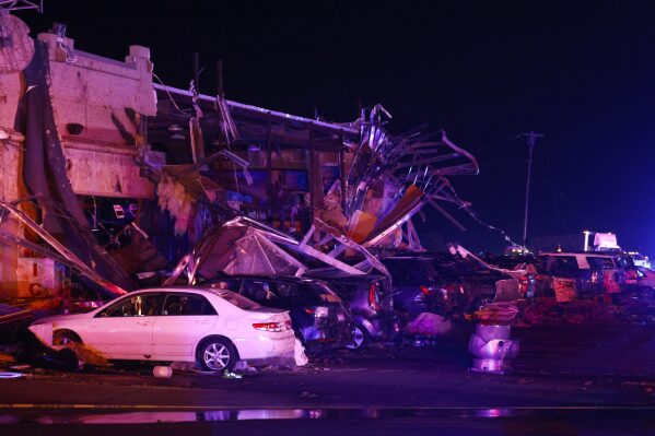 Several cars are seen heavily damaged outside the remains of a Shell gas station after a suspected tornado, Sunday, May 26, 2024, in Valley View, Texas. (Elías Valverde II/The Dallas Morning News via AP)
