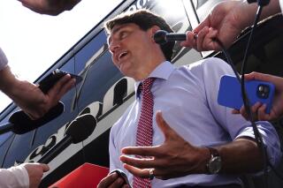 Canadian Prime Minister Justin Trudeau talks with reporters after taking part in a virtual G7 meeting on the crisis in Afghanistan from Hamilton, Ontario, on Tuesday, Aug 24, 2021. (Sean Kilpatrick/The Canadian Press via AP)