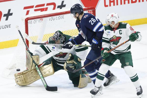 Minnesota Wild's Marc-Andre Fleury (29) saves the shot from Winnipeg Jets' Blake Wheeler (26) as Jared Spurgeon (46) defends during the second period of an NHL hockey game, Wednesday, March 8, 2023 in Winnipeg, Manitoba. (John Woods/The Canadian Press via AP)