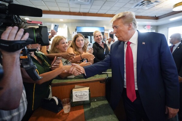 Former President Donald Trump greets supporters at Versailles restaurant on Tuesday, June 13, 2023, in Miami. Trump appeared in federal court Tuesday on dozens of felony charges accusing him of illegally hoarding classified documents and thwarting the Justice Department's efforts to get the records back. (AP Photo/Alex Brandon)