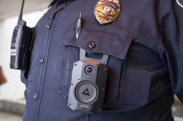 FILE - A police officer wears an Axon body camera on March 28, 2024, at Chugiak High School in Anchorage, Alaska. (Loren Holmes/Anchorage Daily News via AP File)