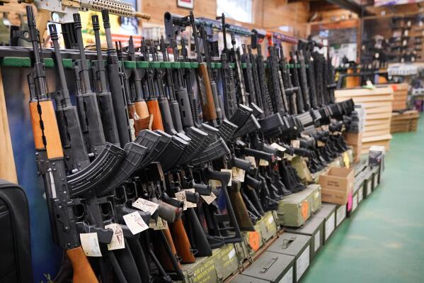 FILE - Semi-automatic rifles are displayed at Coastal Trading and Pawn, Monday, July 18, 2022, in Auburn, Maine. President Joe Biden and the Democrats have become increasingly emboldened in pushing for stronger gun control. The Democratic-led House passed legislation in July to revive a 1990s-era ban on certain semi-automatic guns, with Biden’s vocal support. And the president pushed the weapons ban nearly everywhere that he campaigned this year. (AP Photo/Robert F. Bukaty, File)