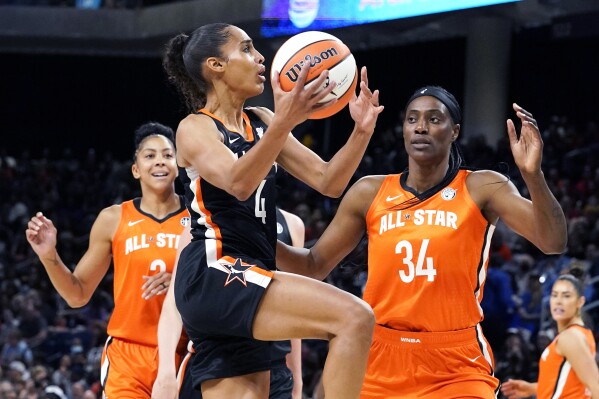 FILE - Team Stewart's Skylar Diggins-Smith, center, drives to the basket against Team Wilson's Candace Parker, left, and Sylvia Fowles during the first half of a WNBA All-Star basketball game in Chicago, Sunday, July 10, 2022. Seattle signed Skylar Diggins-Smith as WNBA free agency tipped off Thursday, Feb. 1, 2024. (AP Photo/Nam Y. Huh, File)