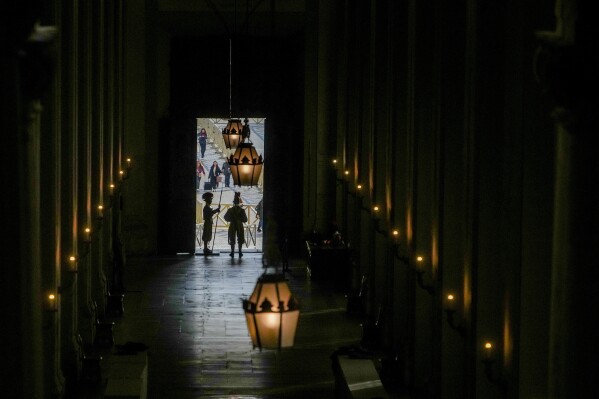 Vatican Swiss guards surveil the Bronze Door, the main entrance to the papal apartments, at The Vatican, Sunday, Feb. 23, 2025, as Pope Francis was admitted on Feb. 14, at Rome's Agostino Gemelli Polyclinic. (AP Photo/Alessandra Tarantino)