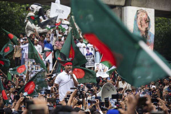 Students and other activists carry Bangladesh's national flag during a protest march organized by Students Against Discrimination to mark one month since former Prime Minister Sheikh Hasina stepped down after a mass uprising, in Dhaka, Bangladesh, Thursday, Sept. 5, 2024. (AP Photo/Rajib Dhar)