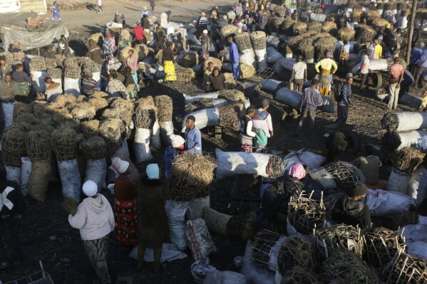 FILE - People gather to buy charcoal at a busy market in Lusaka, Zambia, July, 5, 2021. The French government says Thursday, June 22, 2023, that Zambia has reached a deal with China and several other government creditors to restructure $6.3 billion in loans. (AP Photo/Tsvangirayi Mukwazhi, File)