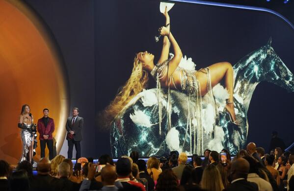 Beyonce, left, accepts the award for best dance/electronic music album for "Renaissance" at the 65th annual Grammy Awards on Sunday, Feb. 5, 2023, in Los Angeles. James Corden looks on from right.(AP Photo/Chris Pizzello)