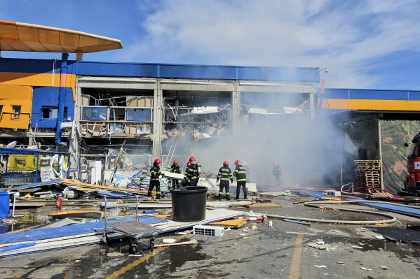 In this photo released by Romanian Emergency Services (ISU Botosani), firefighters work at the scene of an explosion at a chain DIY store in Botosani, Romania, Friday, June 7, 2024. An explosion at a chain DIY store in northwest Romania on Friday injured at least 13 people, one seriously, but caused no fatalities, authorities said.(Romanian Emergency Services - ISU Botosani via AP)