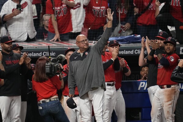 Cleveland Guardians manager Terry Francona, center, waves after the Guardians defeated the Cincinnati Reds in a baseball game Wednesday, Sept. 27, 2023, in Cleveland. (AP Photo/Sue Ogrocki)