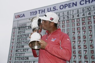FILE - In this June 16, 2019, file photo, Gary Woodland poses with the trophy after winning the U.S. Open golf tournament in Pebble Beach, Calif. The U.S. Open is returning to NBC starting this year at Winged Foot after Fox Sports has asked to end its 12-year contract with the USGA, multiple people told The Associated Press on Sunday night, June 28, 2020. (AP Photo/Carolyn Kaster, File)
