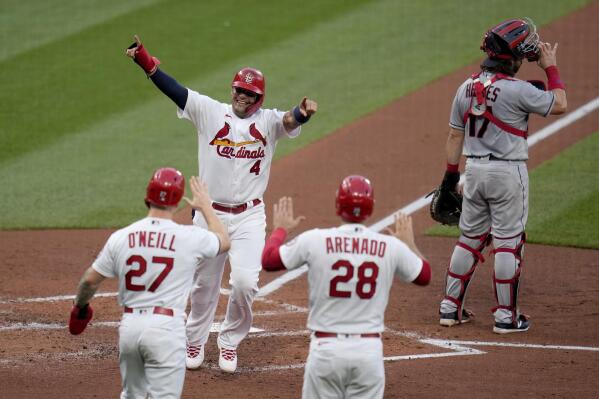 St. Louis Cardinals' Yadier Molina (4) celebrates with teammates Tyler O'Neill (27) and Nolan Arenado (28) after scoring on a three-run double by Matt Carpenter as Cleveland Indians catcher Austin Hedges, right, stands at the plate during the first inning of a baseball game Wednesday, June 9, 2021, in St. Louis. (AP Photo/Jeff Roberson)