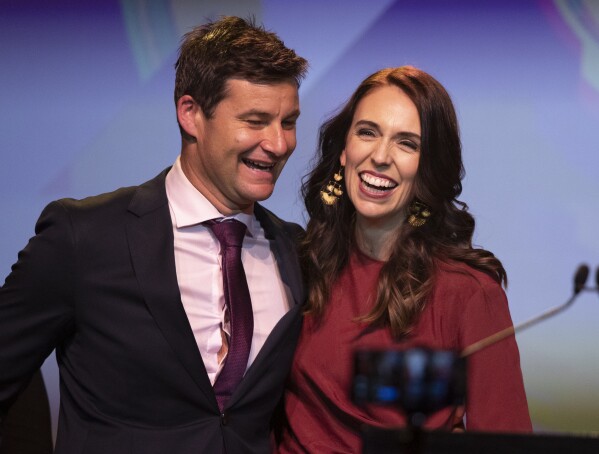 FILE - New Zealand Prime Minister Jacinda Ardern, right, is congratulated by her partner Clarke Gayford following her victory speech to Labour Party members at an event in Auckland, New Zealand, Oct. 17, 2020. (AP Photo/Mark Baker, File)