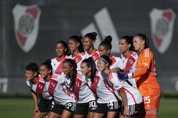 Ichika Egashira, from Japan, bottom row, far right, poses for photos with her team River Plate before facing Boca Juniors at a professional women's soccer match in Ezeiza on the outskirts of Buenos Aires, Argentina, Sunday, March 10, 2024. Egashira is part of a growing group of foreigners joining the Argentinian league as it seeks to boost its recently turned professional women's soccer teams. (AP Photo/Natacha Pisarenko)