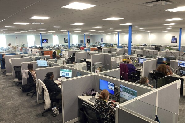 Workers at a Medicaid call center in Jefferson City, Mo., field questions and review information regarding eligibility determinations on Wednesday, Aug. 16, 2023. Federal Medicaid officials have raised concerns that call center wait times are too long in 16 states, including Missouri. States are handling an influx of questions after a pandemic-era moratorium on removing people from Medicaid ended this spring. (AP Photo/David A. Lieb)