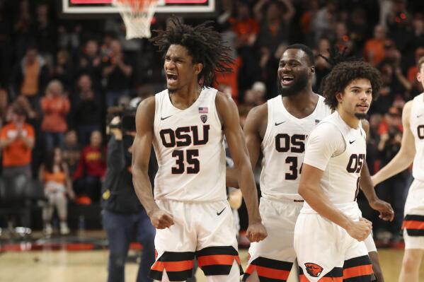 Oregon State's Glenn Taylor Jr., left, Rodrigue Andela, center, and Jordan Pope, right, celebrate after their win over Southern California in an NCAA college basketball game in Corvallis, Ore., Saturday, Feb. 11, 2023. (AP Photo/Amanda Loman)