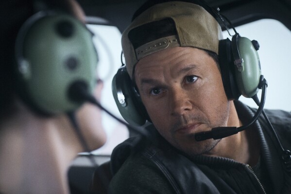 This image released by Lionsgate shows Michelle Dockery, left, and Mark Wahlberg in a scene from "Flight Risk." (Lionsgate via AP)